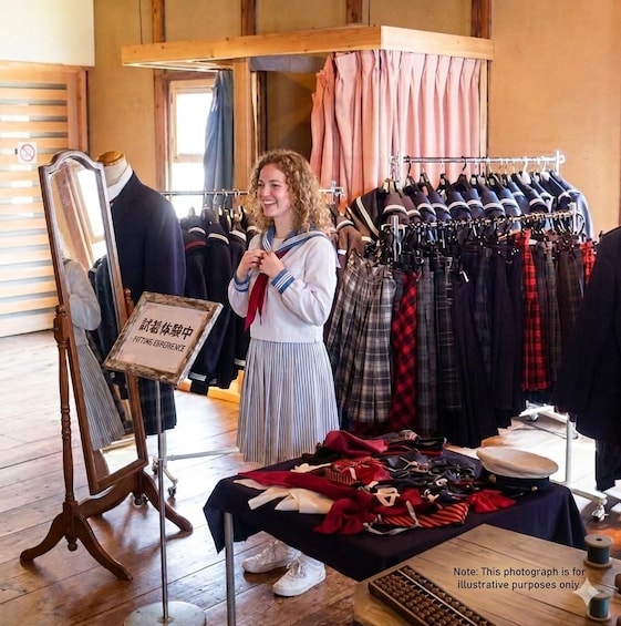 A person standing in a clothing store, a mannequin, and a rack of clothes. 1