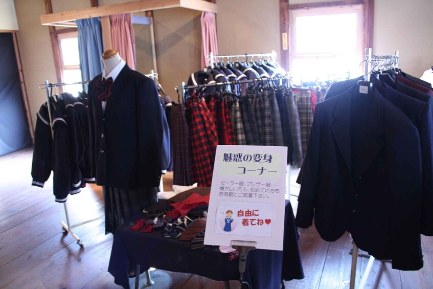 A clothing store with various garments on display, including a mannequin dressed in a suit. 3