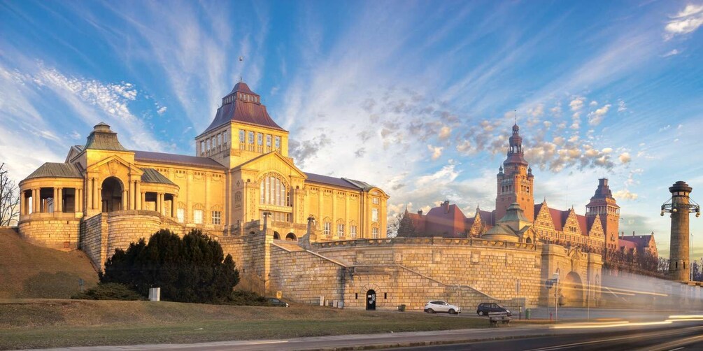 A historic building with a large dome and a tower, surrounded by a stone wall and a moat. 1