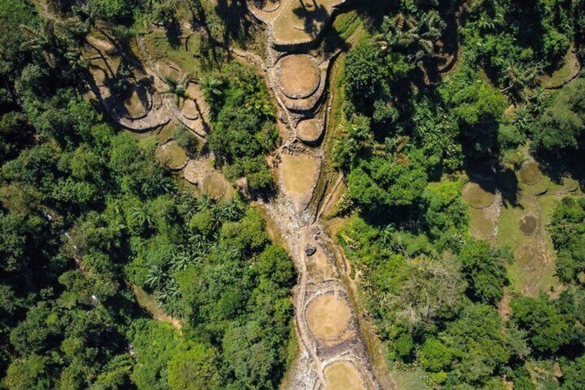 An aerial view of a river with surrounding dense vegetation and terraced fields. 1