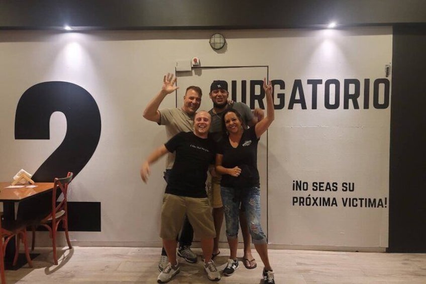 A group of people in a room with a large number '2' and a sign that says 'BURGATORIO'. 2
