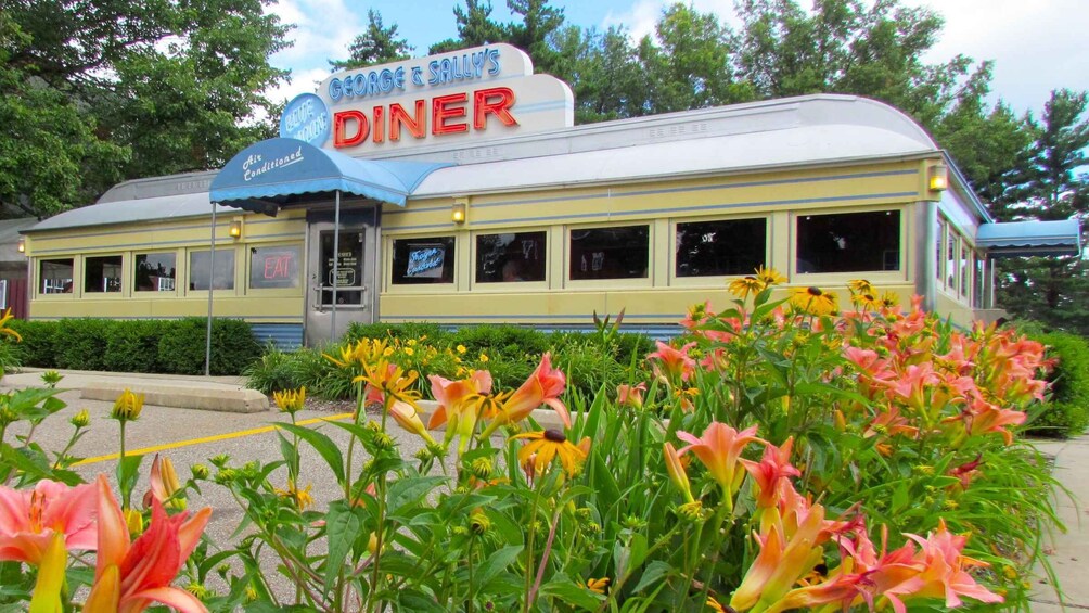A diner with a blue awning and a sign that reads 'George & Sally's Diner.' 3