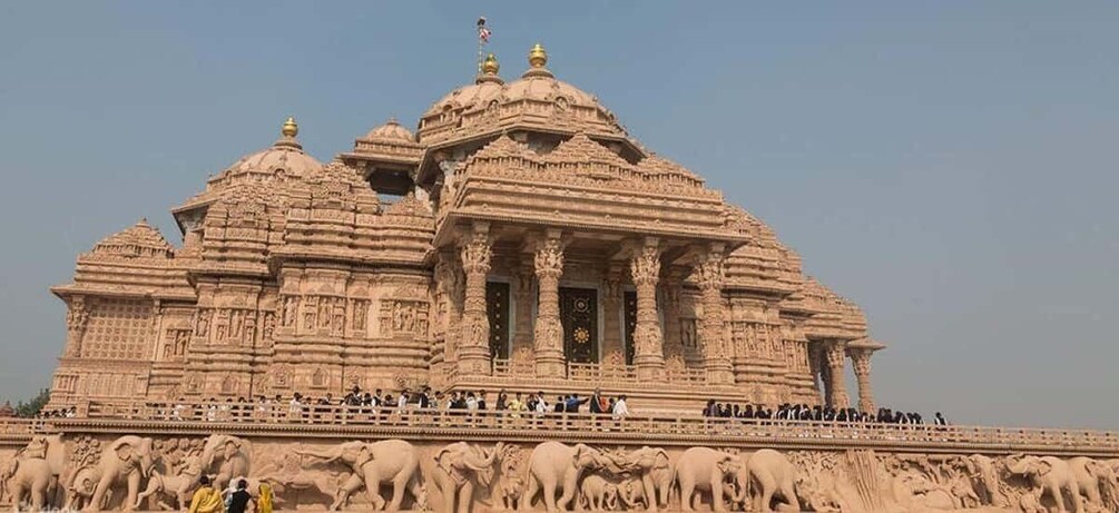 A large, intricately carved temple with multiple domes and a central doorway. 5