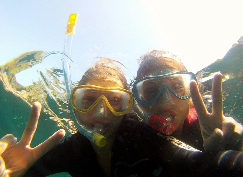 Two people snorkeling with snorkels and masks. 2