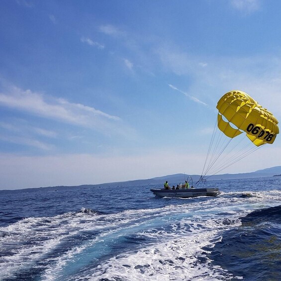 A yellow parachute with the number 06078, a boat, and the ocean. 2