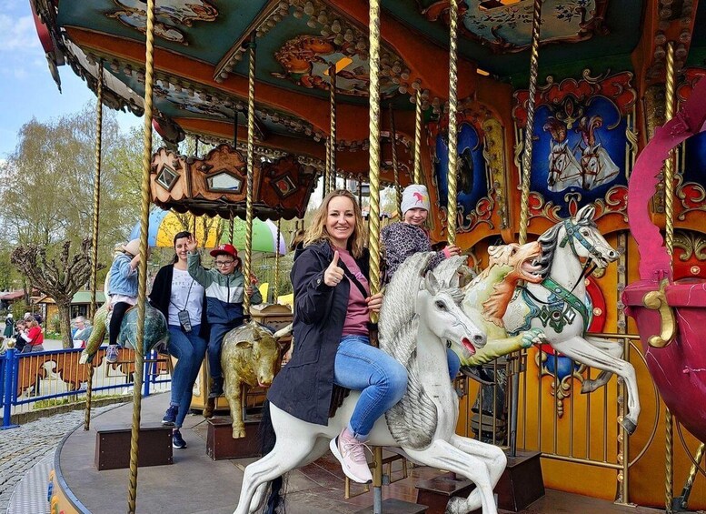 A carousel with colorful horses and riders. 3