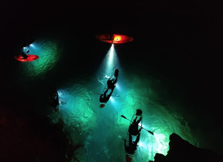 A diver in a cave with a red light source above. 2