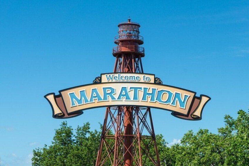 A tall tower with a sign that reads 'Welcome to MARATHON.' 5