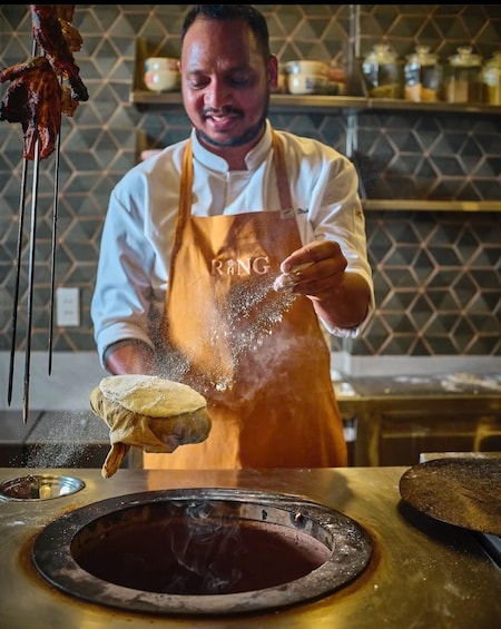 A chef seasoning food with spices. 3