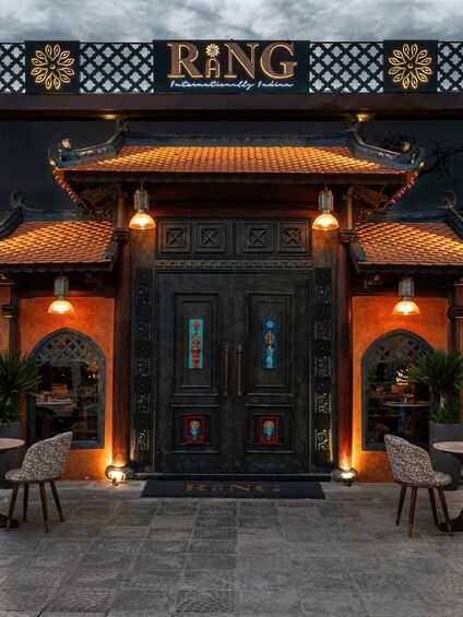 A traditional building with ornate doors and a sign that reads 'RANG Internationally Indian.' 1