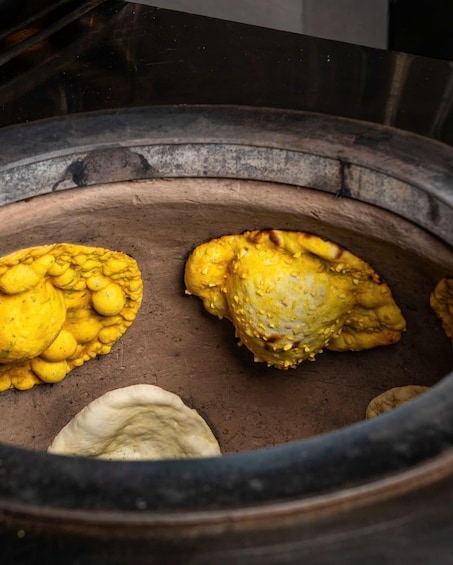 A cooking pot with two yellowish-brown items and a white item inside. 2