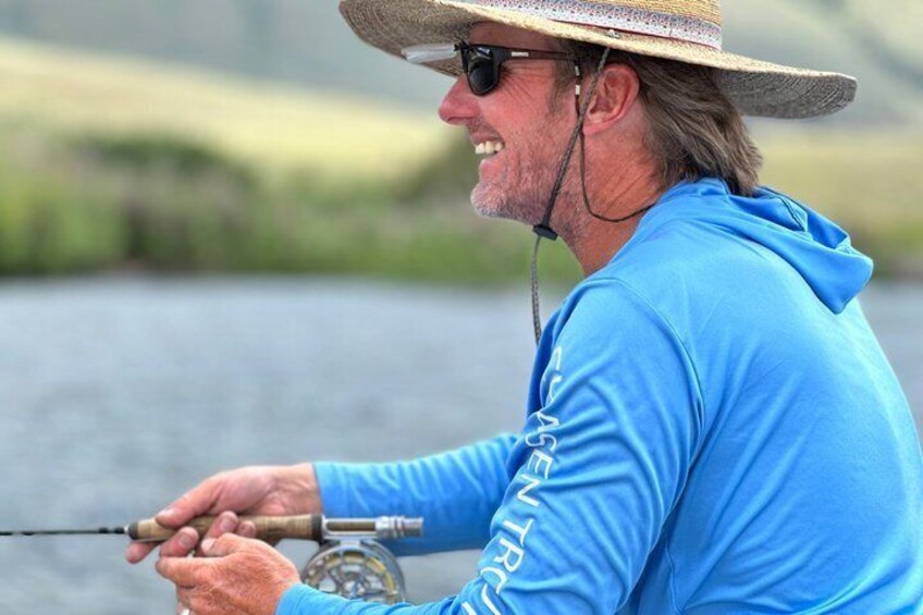 A person fishing by a body of water. 5