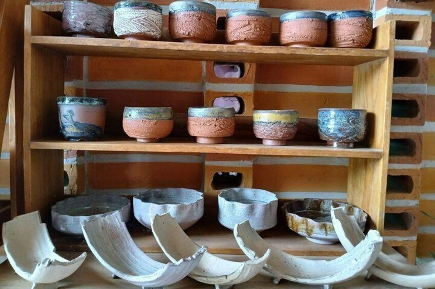 A display of pottery with various shapes and colors. 4