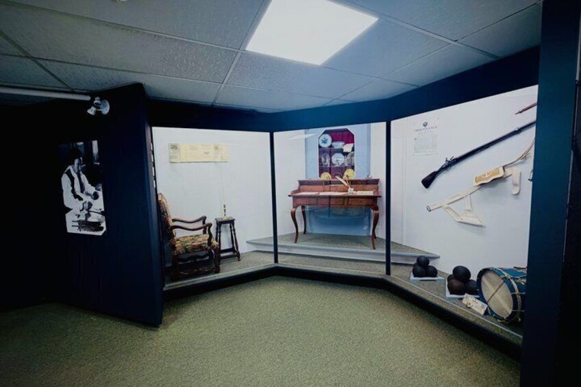 A room with a desk, chair, and various items on the wall. 3