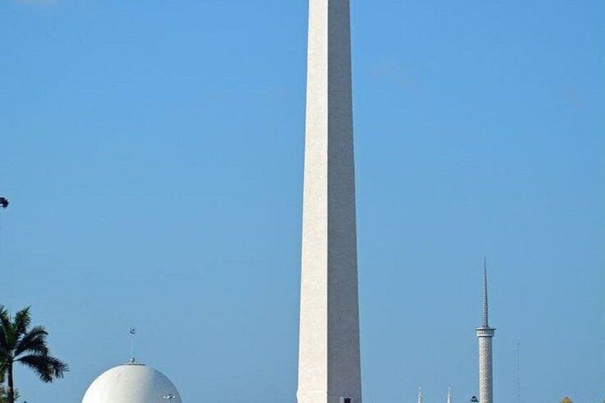 A tall white obelisk, a white dome, and a tower with a spire. 5