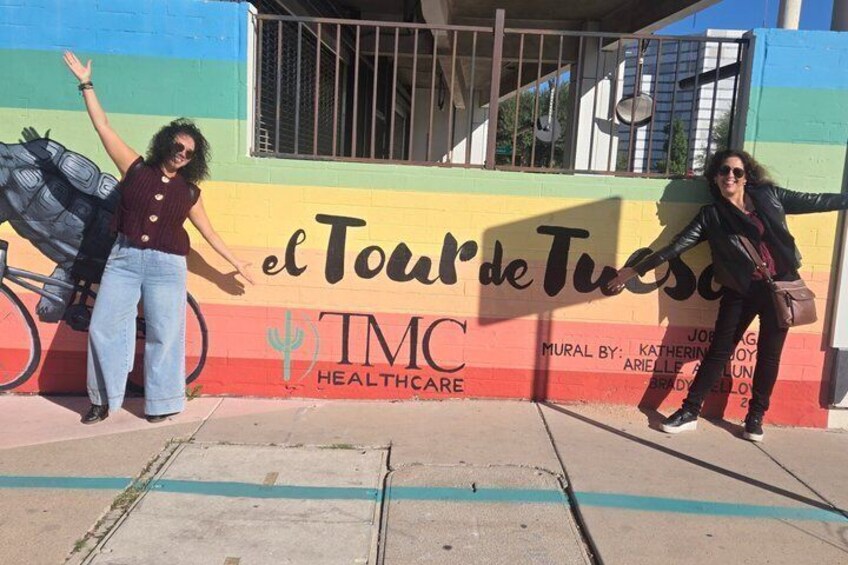 A mural with the text 'el Tour de Tucson' and 'IMC Healthcare' on a building. 1
