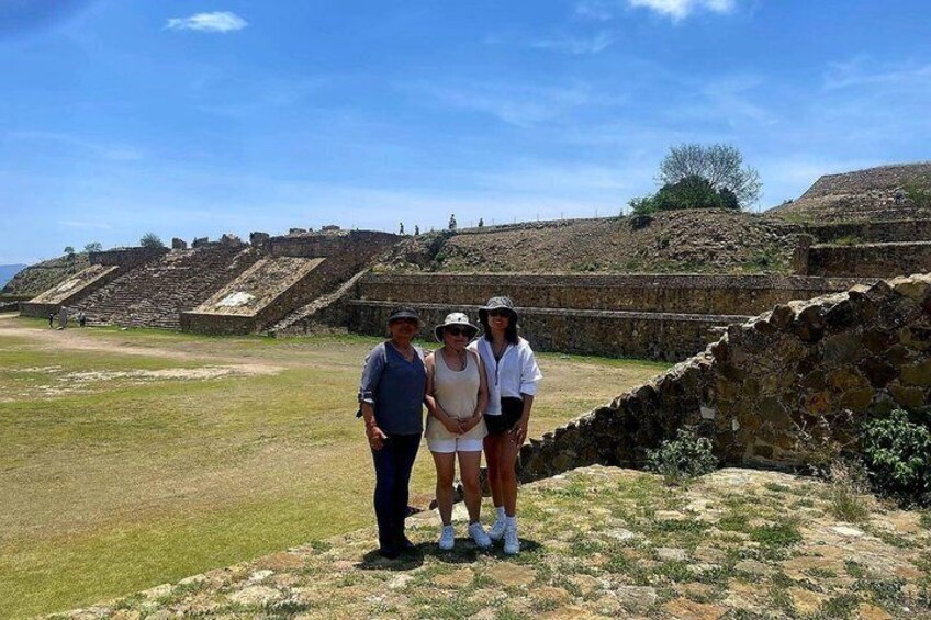 A historical site with ruins and a grassy area. 2