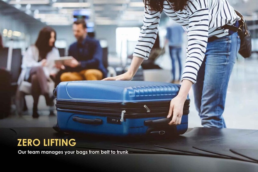 A person placing a blue suitcase on a conveyor belt in an airport. 4