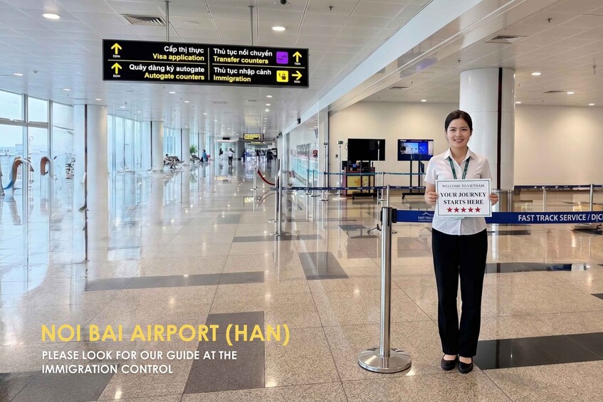 A person holding a sign at Noi Bai Airport (Hanoi) with a guide at the immigration control. 2