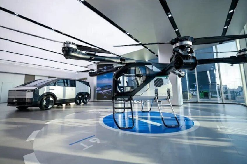 A futuristic vehicle and a drone in a modern indoor setting. 2
