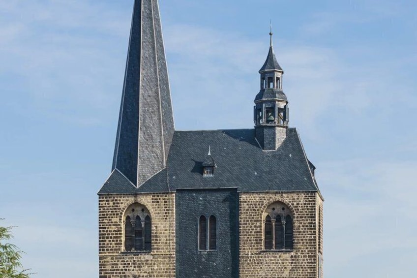 A church with a tall spire and a bell tower. 4