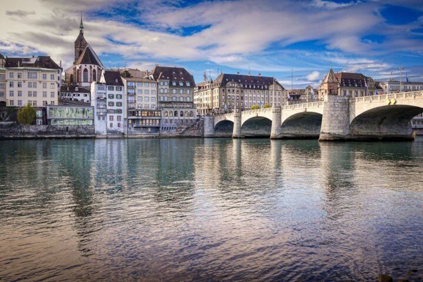 A river with a stone bridge and historic buildings. 2
