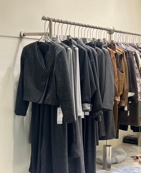 A clothing rack with various garments including coats and jackets. 3