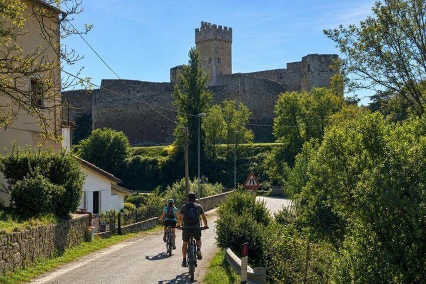 A road with cyclists, a castle in the background, and a rural setting. 4