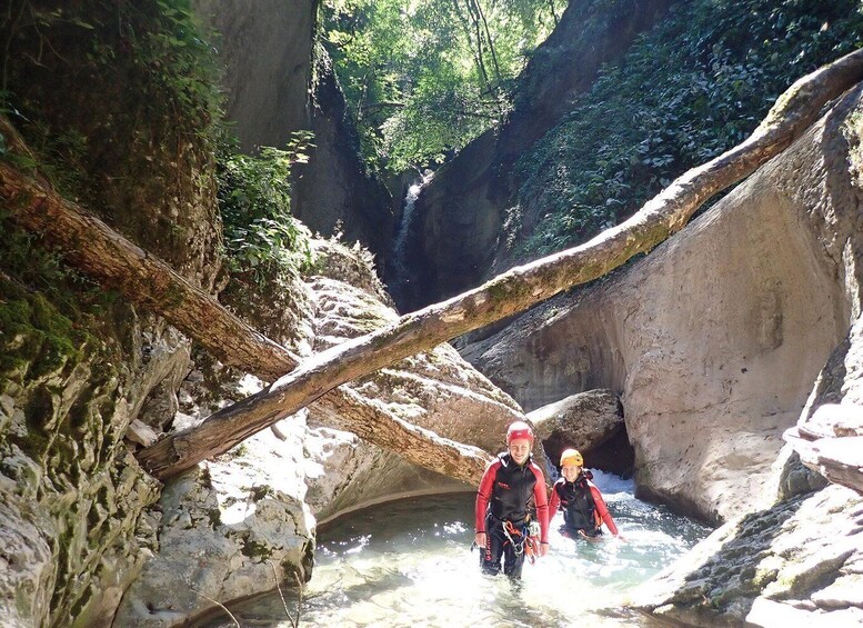 Two people in a rocky canyon with a waterfall. 4