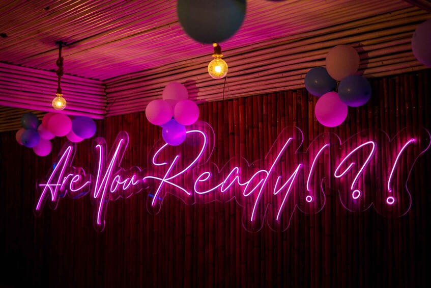 A neon sign with the text 'Are You Ready?!?' and balloons. 5