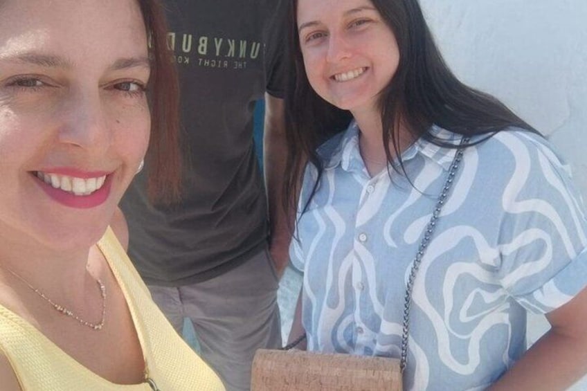 Two people standing close together, one wearing a yellow top and the other in a blue and white patterned shirt. 5