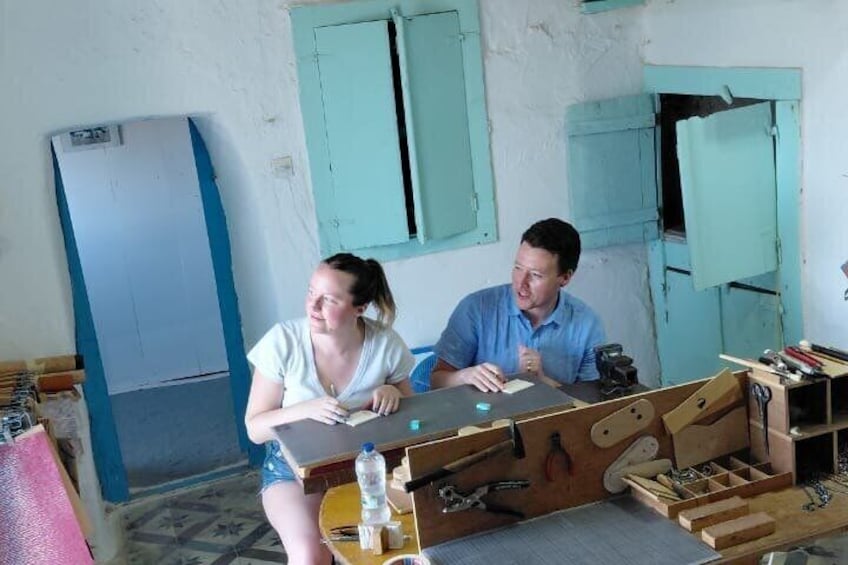 A workshop with a workbench, tools, and a person working on a project. 4