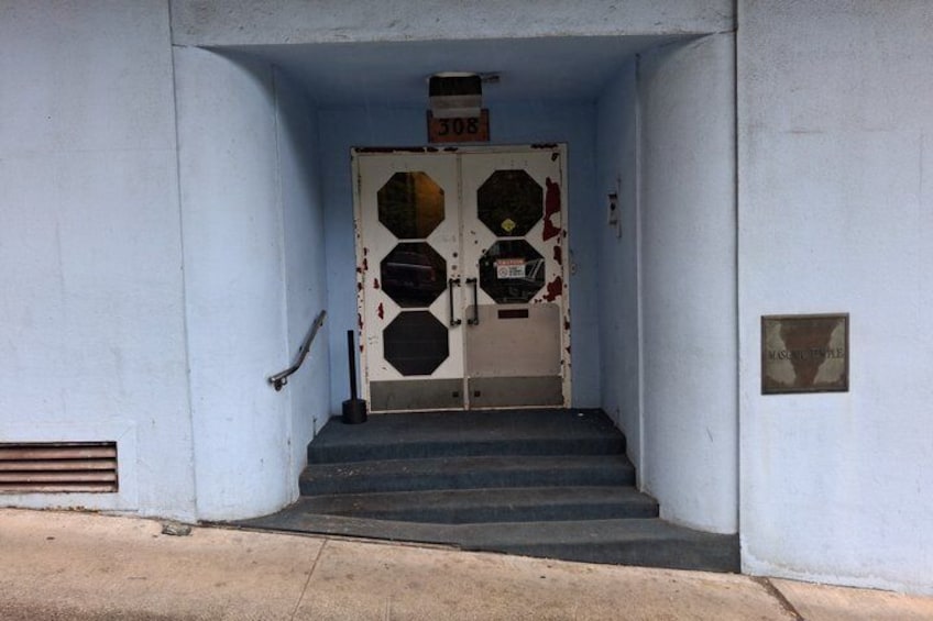 A set of stairs leading to a door with a sign above it. 3