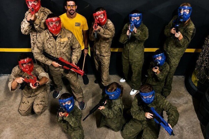 A group of people in military-style gear and paintball masks. 5
