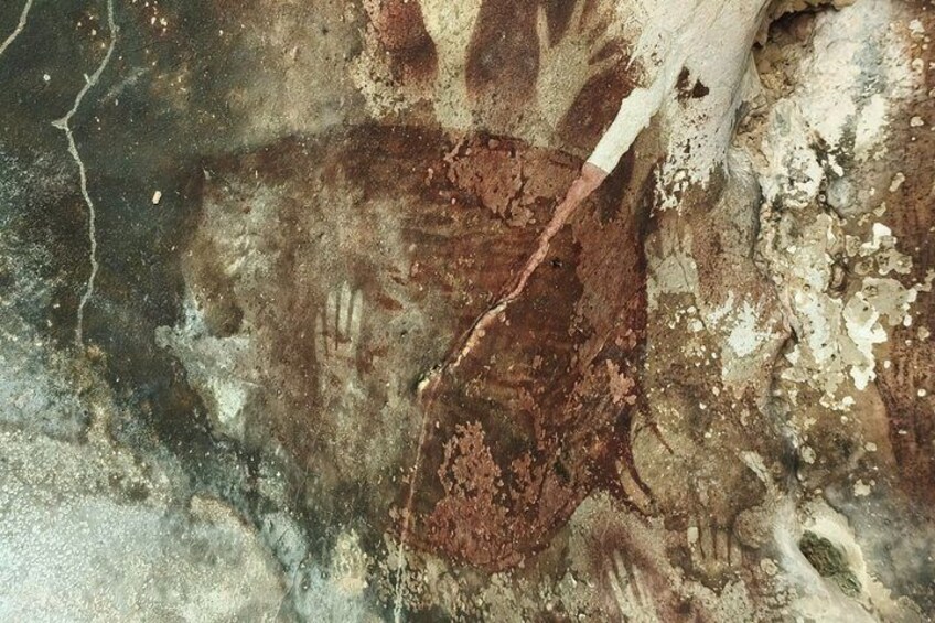 A close-up of a rock surface with a white tape marking. 2