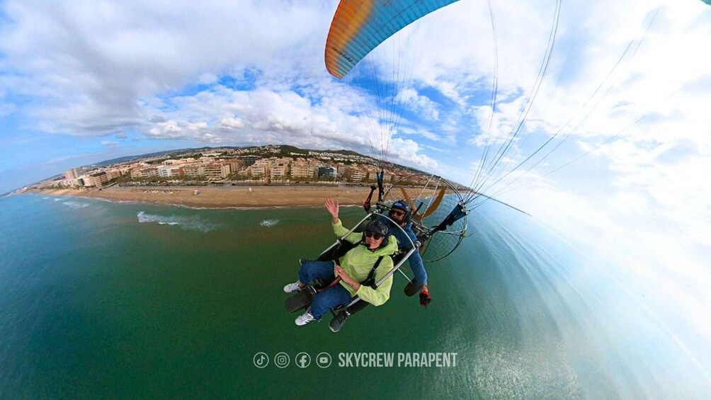 A paragliding activity with a coastal cityscape in the background. 4