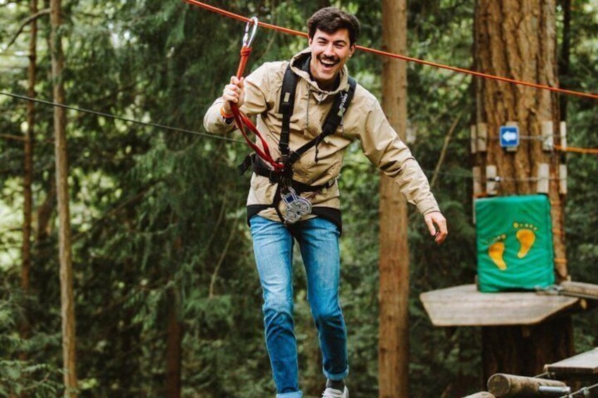 A person on a zip line in a forest. 1