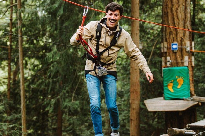 A person on a zip line in a forest. 1