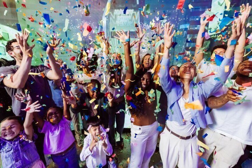 A group of people celebrating with confetti in the air. 1