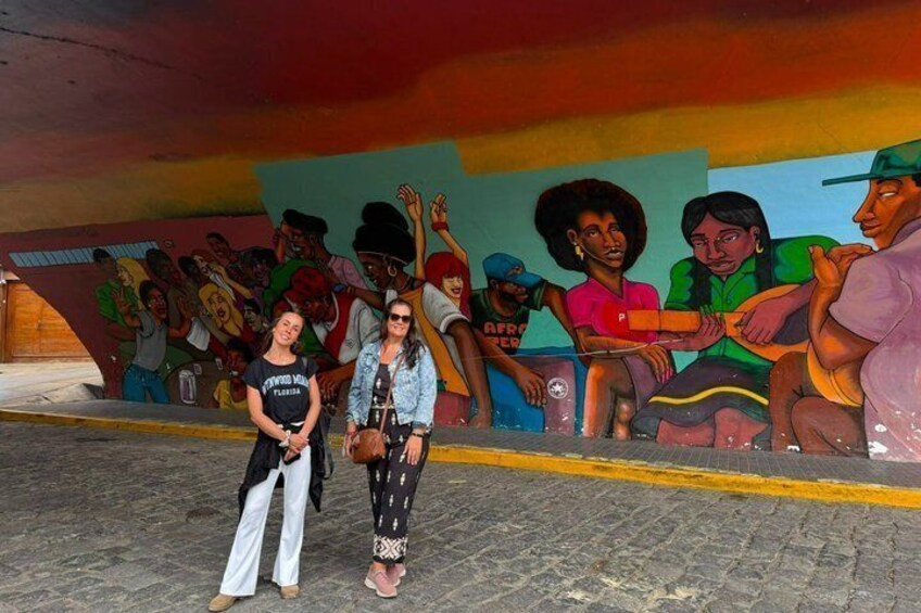 A mural with people and a street. 1
