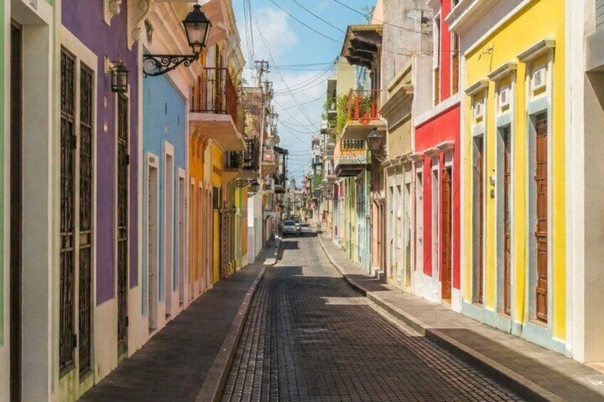 A narrow street lined with colorful buildings. 3