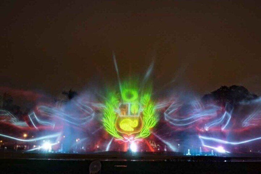 A nighttime light show with colorful beams and patterns. 5