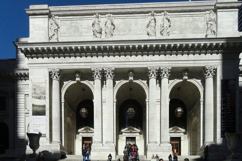 A classical building facade with three large arches and a central entrance. 2