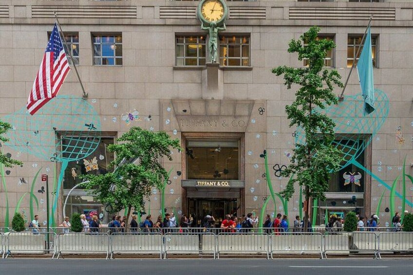 A building with a clock, American flag, and decorative elements. 5