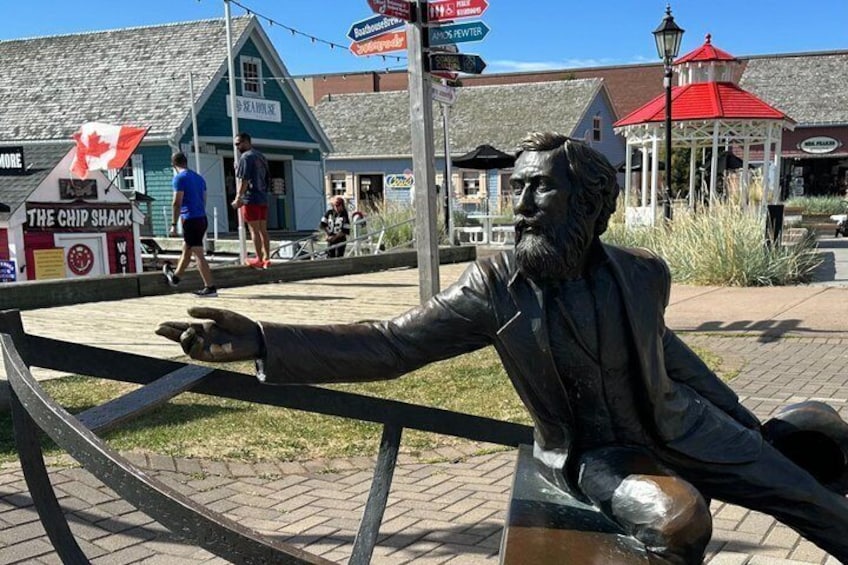A statue of a man leaning on a fence, a chip shack, and a red-roofed building. 2