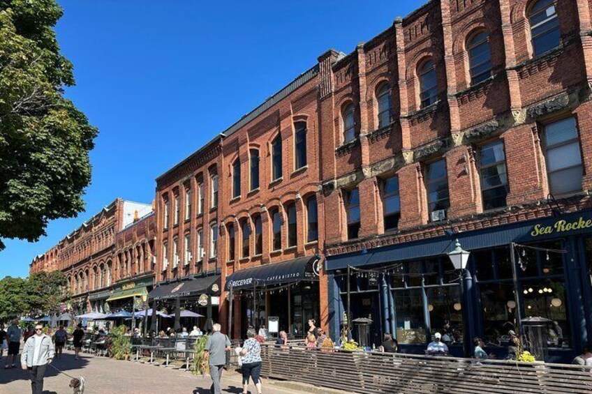 A brick building with a storefront named 'Sea Rockers.' 1