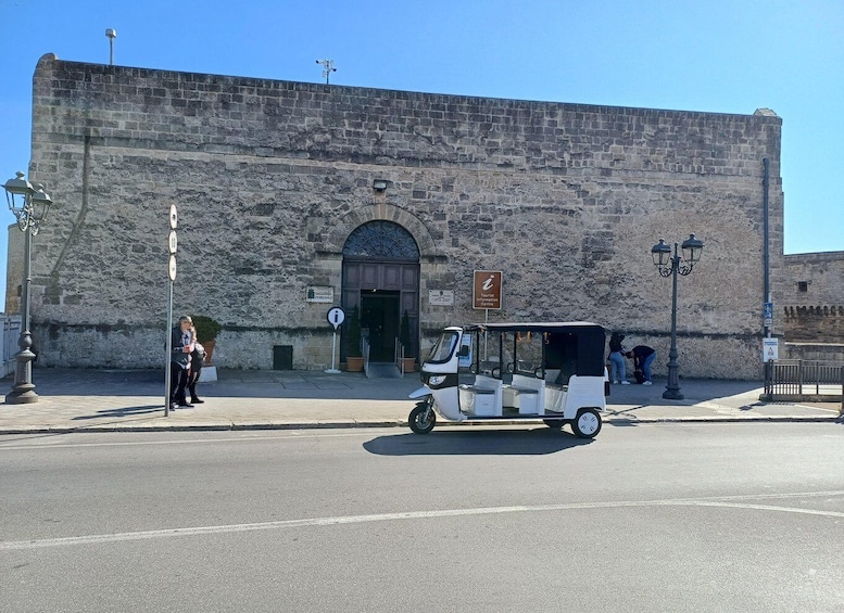 A historic stone building with a sign for a tourist information center. 3