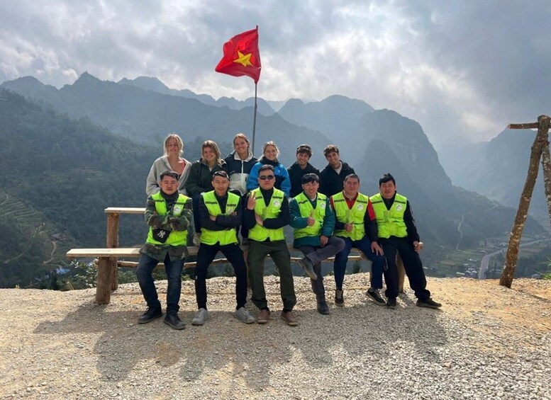 A group of people on a mountain with a flag. 1