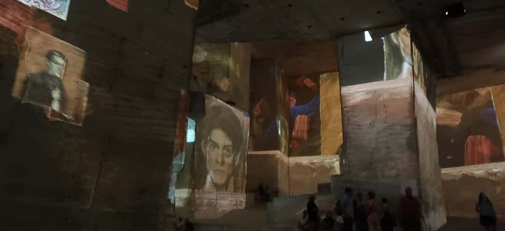 A historical building with large murals and stone walls. 2