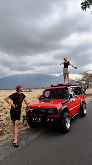 A red SUV parked on a road with a license plate reading 'N 1427 HT'. 5